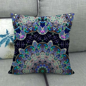 Detailed texture of bohemian mandala throw pillow cover on a grey fabric sofa