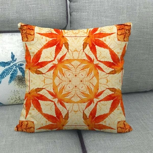 Detailed macro shot of symmetric orange maple leaf pattern on linen throw pillow cover