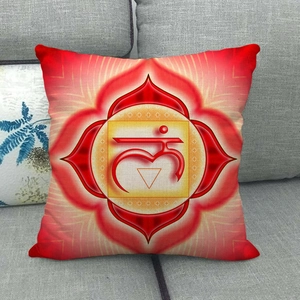 Detail of red Bohemian linen pillow with chakra pattern on a gray fabric sofa