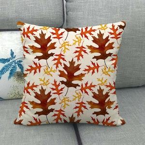 Detail of fall maple leaf print on textured cotton linen pillowcase over a grey sofa