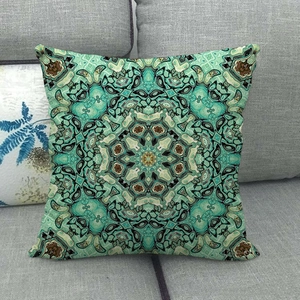 Close-up of geometric mandala linen pillowcase on a grey sofa with bohemian texture