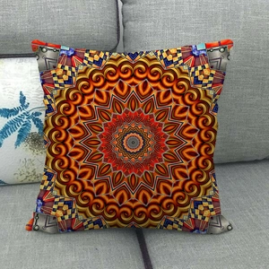 Close-up of geometric mandala pattern on square linen pillow cover over grey sofa