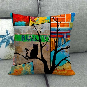 Artistic watercolor cat silhouette pillow cover displayed on a gray fabric sofa