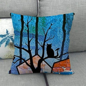 Detailed close-up of a linen cushion with artistic cat and bird silhouette on a grey sofa
