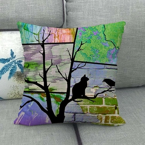 Close-up of artistic watercolor cat on tree linen pillowcase on a grey sofa