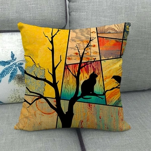 Artistic cat and tree collage pillowcase on a grey sofa with vibrant geometric patterns