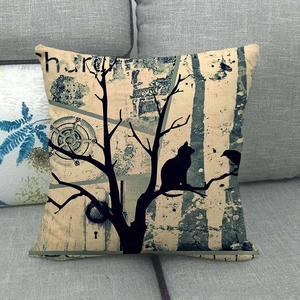 Detailed texture of linen pillowcase with cat and tree watercolor art on grey sofa
