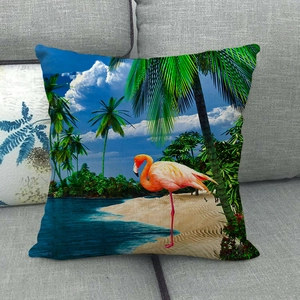 Detail of linen cushion cover showing pink flamingo and tropical beach print texture