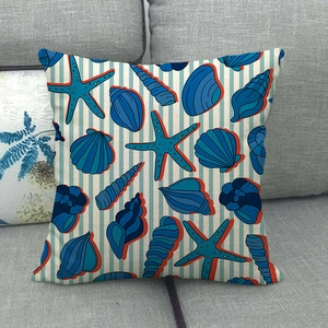 Detailed view of linen texture pillowcase with starfish and seashell patterns on a sofa