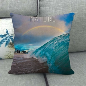 Detail of linen pillowcase featuring a beach wave and rainbow print with NATURE text