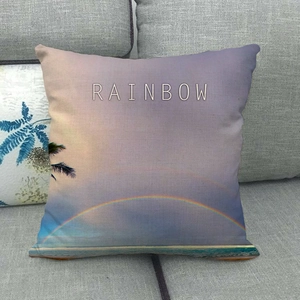 Macro detail of breathable linen pillow cover featuring a coastal rainbow print on sofa