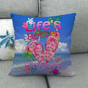 Detail of linen pillow cover with beach print and Life's Better in Flip Flops text