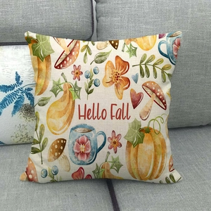 Dettaglio del tessuto in lino del cuscino autunnale con stampe di zucche e scritte decorative