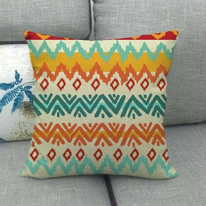 Abstract geometric linen throw pillow cover with colorful bohemian patterns on a sofa