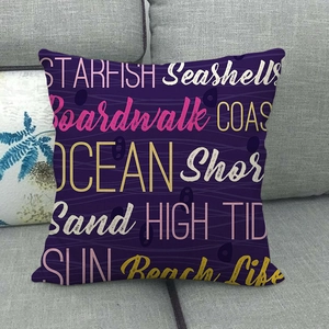 Detailed view of dark purple linen pillowcase with ocean theme typography on a sofa