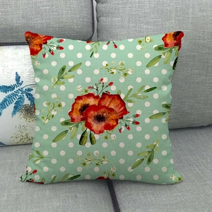 Detailed texture of mint green linen pillowcase with red poppy flower and white polka dots