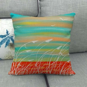Detailed texture of linen cushion cover featuring sunset coastal landscape and reeds