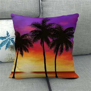 Close-up of tropical palm tree watercolor sunset scene on a textured linen pillow cover