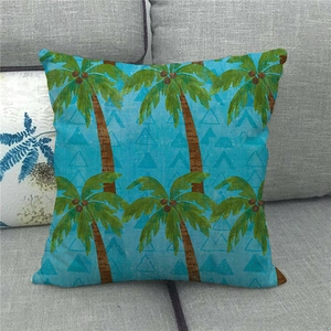 Close-up detail of the linen texture and tropical coconut tree print on the blue cushion cover