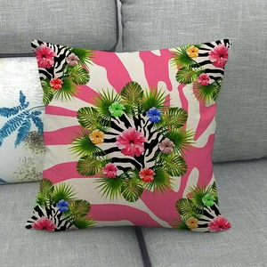 Abstract tropical floral linen pillow cover with vibrant zebra pattern and palm leaves on sofa