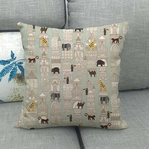 Detail of linen cushion cover featuring vintage architecture and wild animal patterns