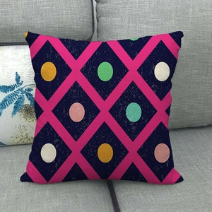 Close-up of geometric pattern linen pillowcase on sofa with navy blue and pink diamond shapes