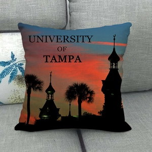 Linen pillow cover with University of Tampa sunset silhouette print on grey sofa