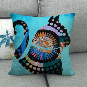 Bohemian teal linen pillow cover featuring an abstract cat silhouette on a gray sofa