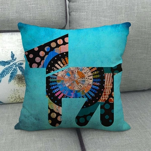 Bohemian blue linen pillowcase with abstract geometric dog pattern on a gray sofa