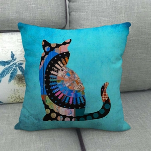 Detail of bohemian linen pillow cover with artistic cat silhouette on gray fabric sofa