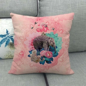 Detailed close-up of elephant and floral mandala patterns on textured linen cushion cover