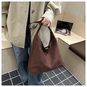 Brown faux suede hobo bag shown in a stylish casual commute setting with a large capacity