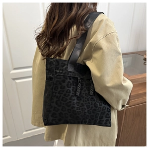 Detail of black leopard print tote bag showing soft fabric texture and sturdy shoulder straps