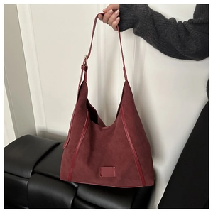 Detailed close-up of dark red hobo tote bag in soft frosted faux suede material