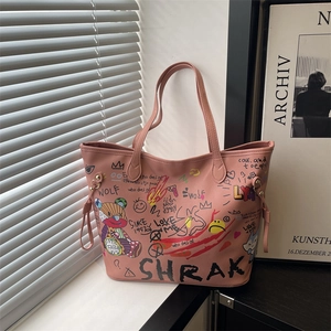 Pink graffiti bucket bag with bear print and litchi texture shown on a windowsill