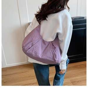 Light purple pleated nylon tote bag shown on model for daily commuting size reference