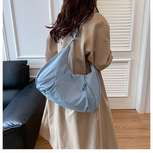 Detailed view of the large light blue crescent hobo bag made of lightweight nylon fabric