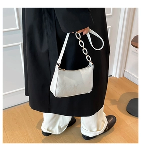 Detail showing high-gloss white faux leather texture and elegant white ring chain strap