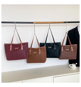 Selection of leopard print tote bags in burgundy, brown, black and coffee with gold bows