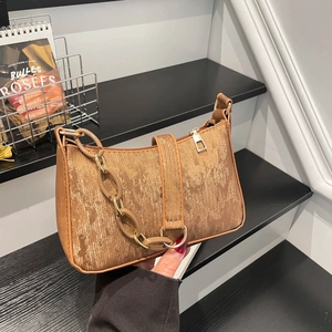 Brown vintage baguette bag with metallic texture and chunky chain decoration