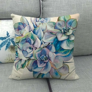 Watercolor blue floral succulent linen pillow cover on a modern gray fabric sofa