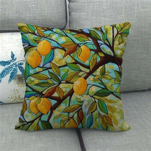 Detail of artistic lemon pattern cushion cover on a gray sofa with watercolor texture