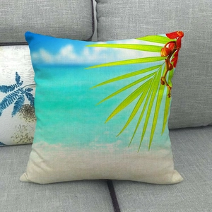 Detail of tropical palm leaf and beach print on linen textured decorative pillow cover