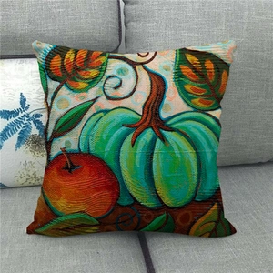 Artistic watercolor pumpkin and apple linen throw pillow cover on a grey sofa