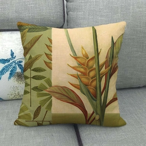 Close-up of tropical palm and monstera leaf print on linen square cushion cover