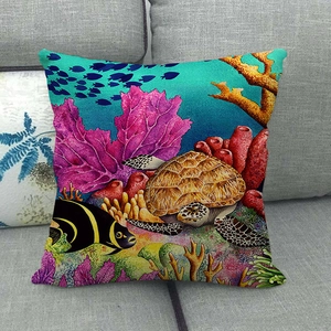 Underwater world linen throw pillow cover featuring turtles and coral on a sofa