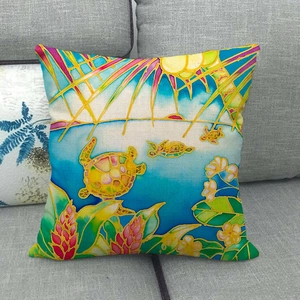 Close-up of linen pillowcase with vibrant sea turtle print and batik floral patterns