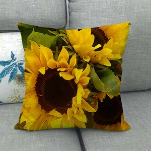 Close-up of watercolor sunflower pattern and textured linen fabric on a square pillow case
