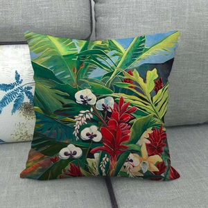 Close-up of tropical floral print on linen pillowcase with red ginger flowers on sofa