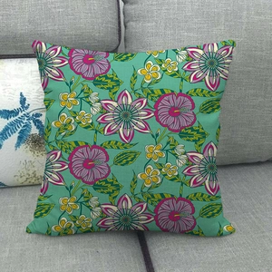 Linen pillowcase featuring tropical pink hibiscus and green leaves on a teal background